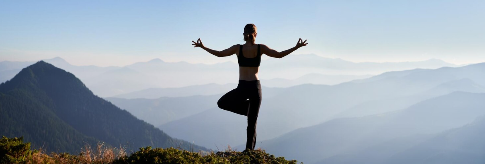 woman meditating on mountain top
